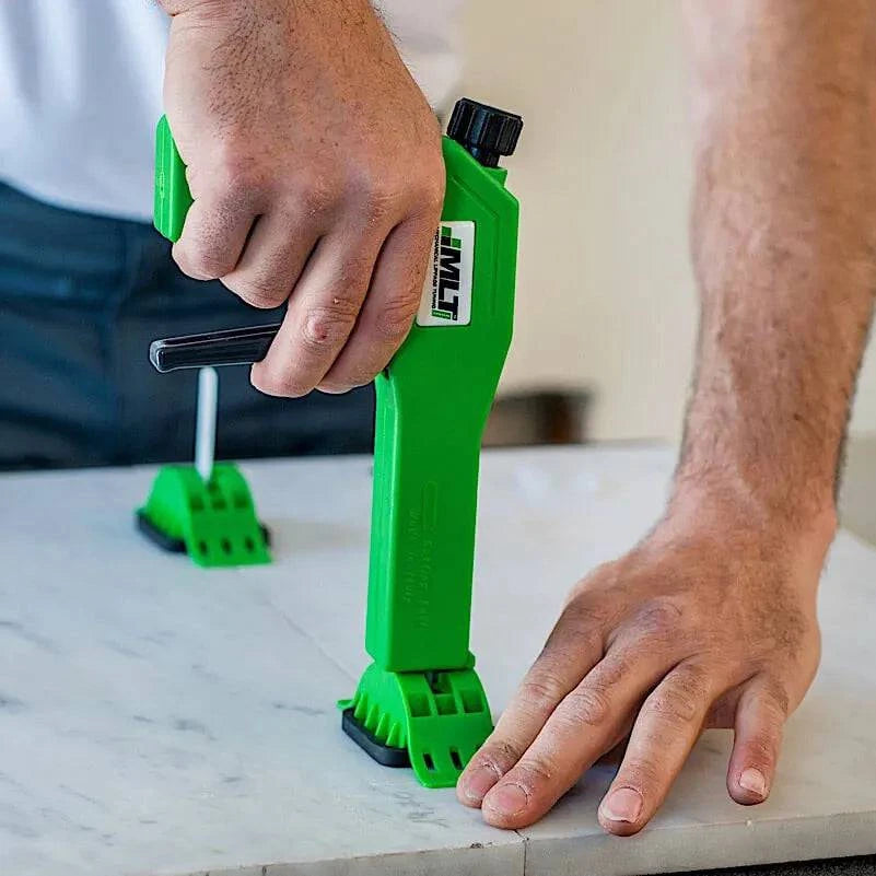 tile or stone, lower the tension locking cap over the re-usable connecting tab to tile or stone surface then, slide cap in direction of the grout joint to engage the lock