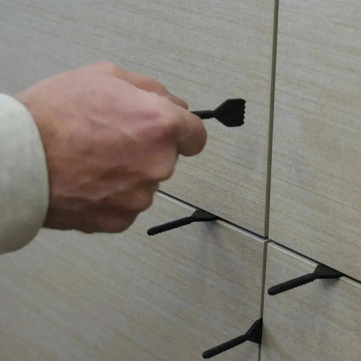 remove the cap and threaded post from the installed tile. Caps can be cleaned and reused